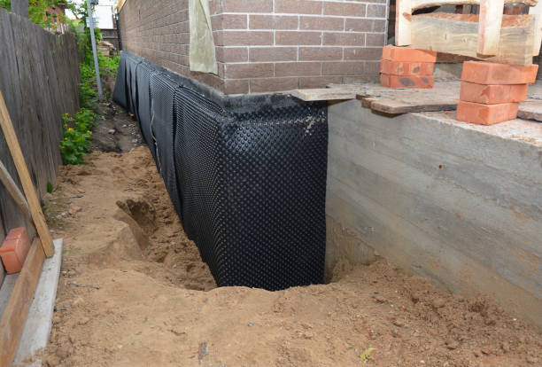 SJ Waterproofing Pros technician performing targeted Basement Waterproofing assessment in Oostburg, WI